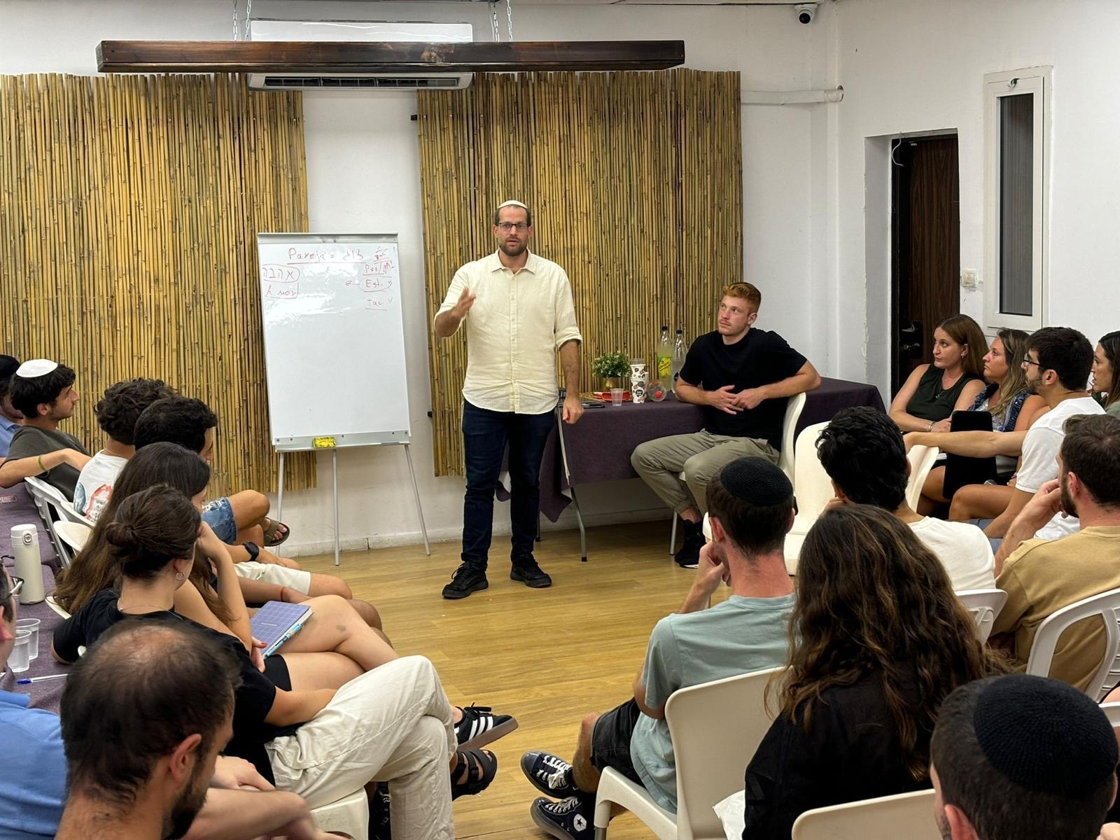 A talk at La Casa with the community seated in a circle