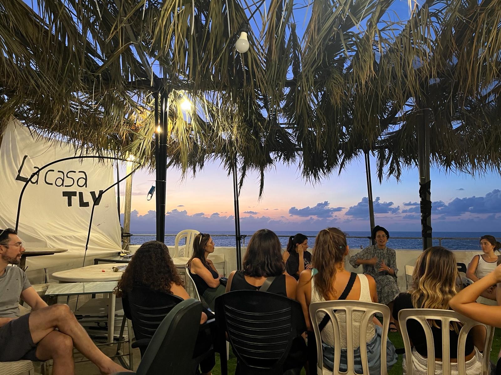 A La Casa gathering on a seaside terrace at sunset